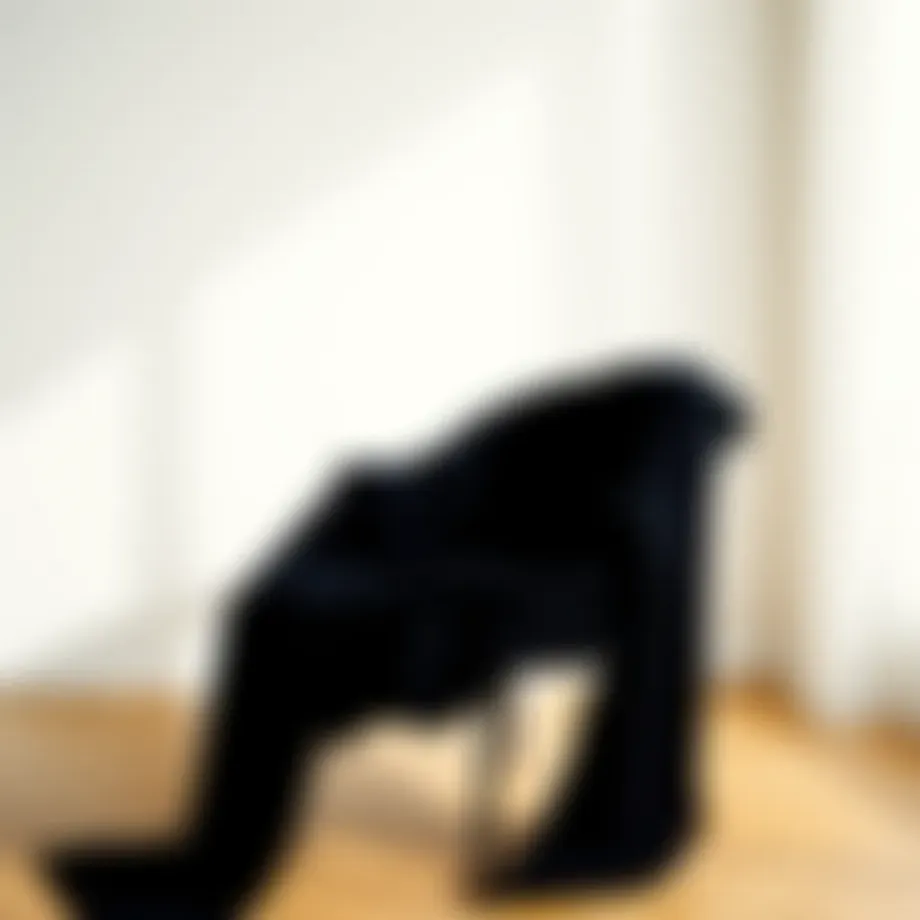 Elegant black knit sweater draped luxuriously over a minimalist chair